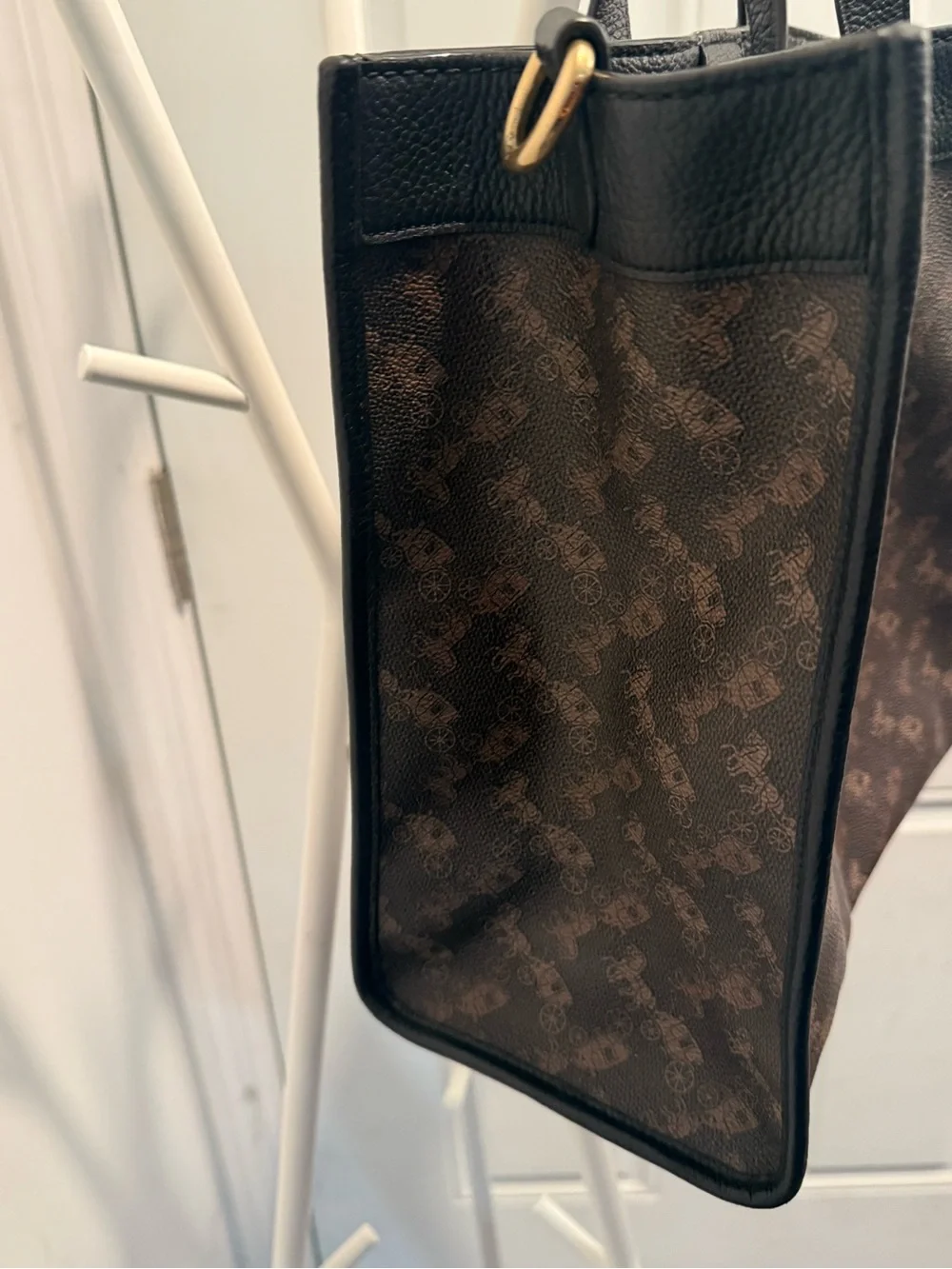 This is a Coach Field Tote in Truffle Black with a horse and carriage print